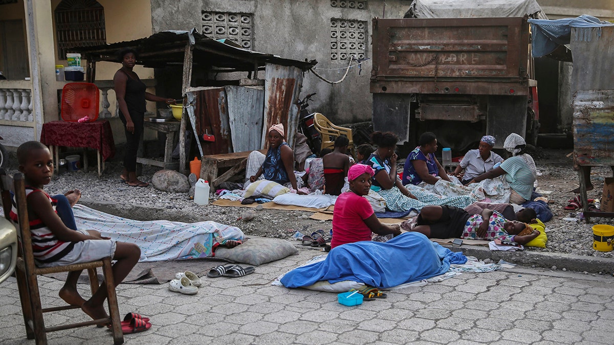 Locals begin to wake up after spending the night outside after Saturday´s  7.2 magnitude earthquake in Les Cayes, Haiti, Sunday, Aug. 15, 2021. (AP Photo/Joseph Odelyn)