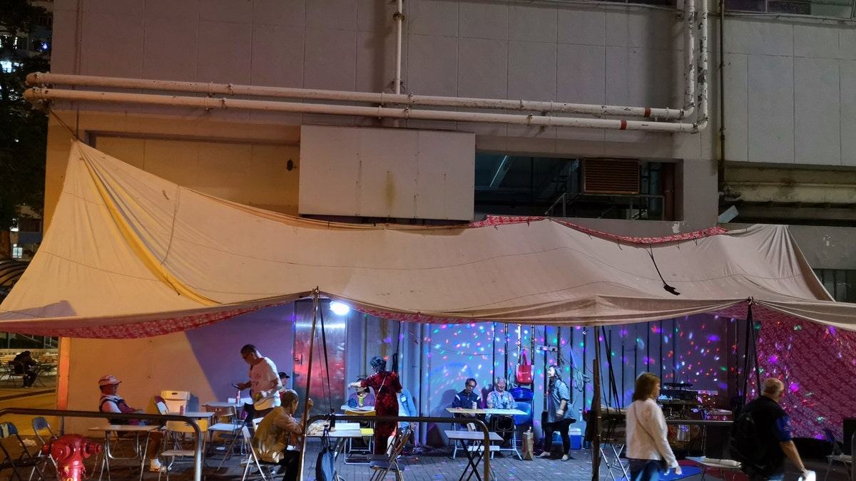 Local people performing Karaoke at a tent on a street in Yau Ma Tei, Kowloon peninsula. Hong Kong