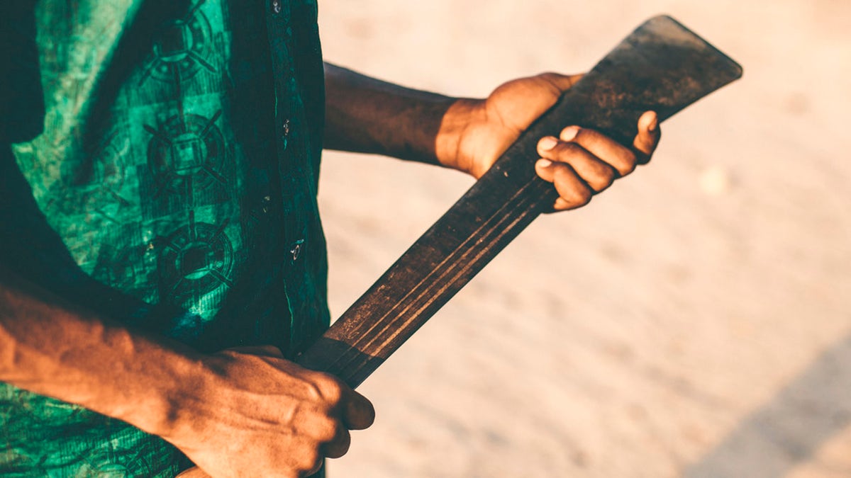 Man holding machete (Stock)