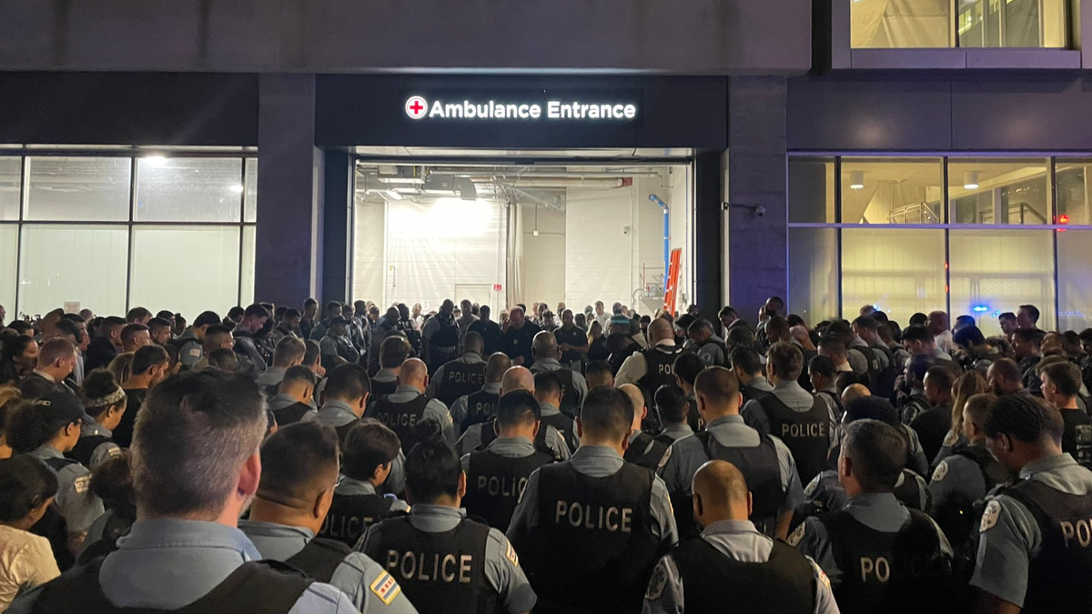 Chicago police officers gather overnight outside the University of Chicago Medical Center, where one officer died and another remained hospitalized after Saturday's shooting incident. (Chicago Police)