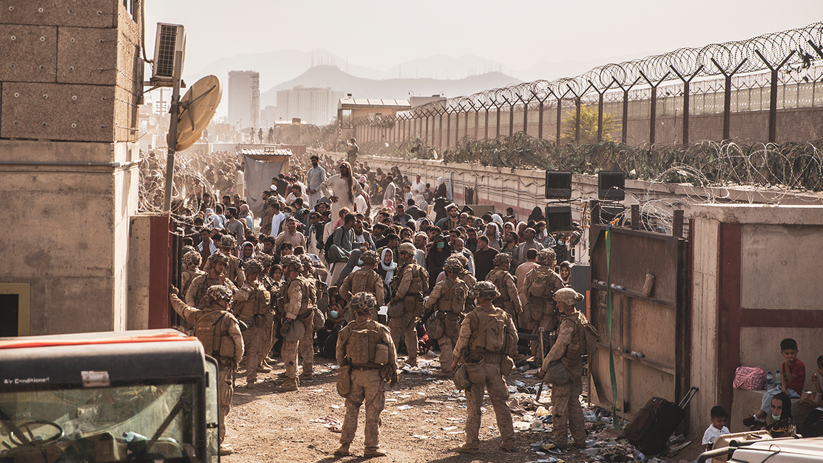 U.S. Marines with Special Purpose Marine Air-Ground Task Force - Crisis Response - Central Command, provide assistance at an Evacuation Control Checkpoint (ECC) during an evacuation at Hamid Karzai International Airport, Kabul, Afghanistan, Aug. 21. 