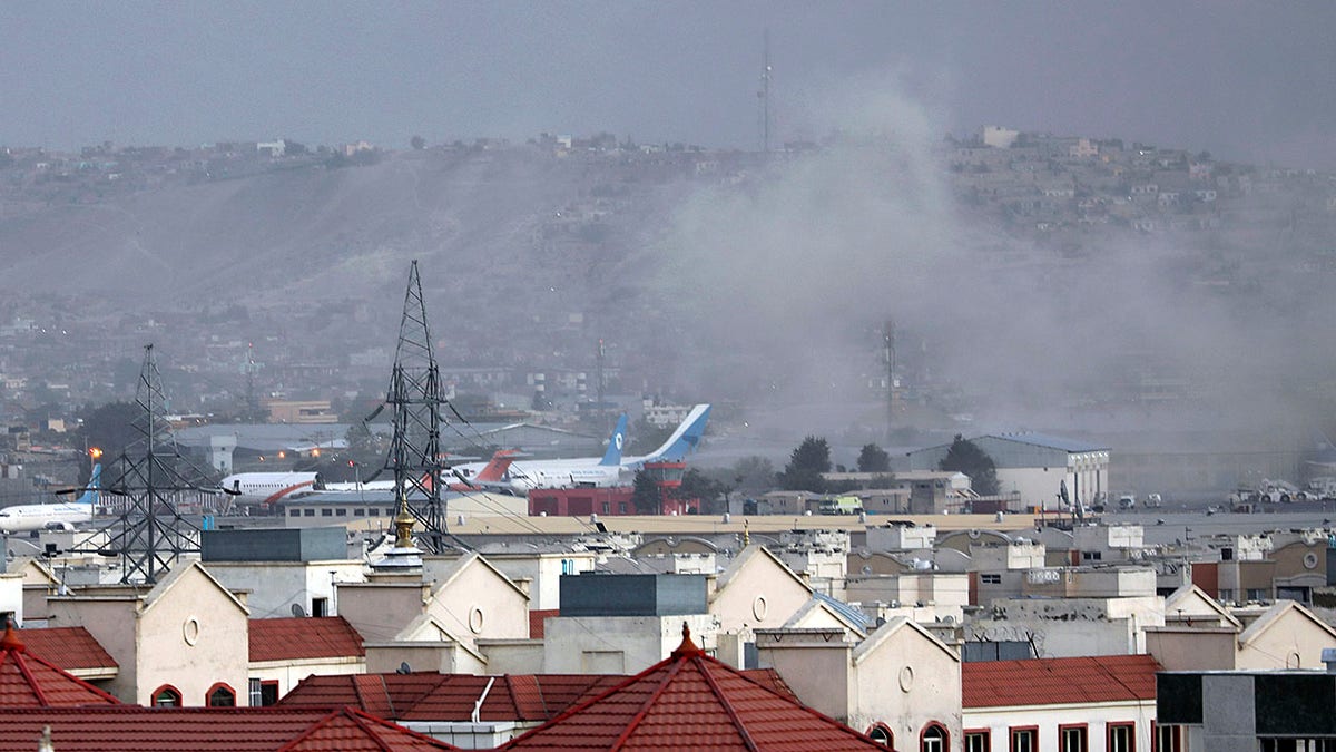 Smoke rises from explosion outside the airport in Kabul, Afghanistan, Thursday, Aug. 26, 2021. The explosion went off outside Kabul’s airport, where thousands of people have flocked as they try to flee the Taliban takeover of Afghanistan. Officials offered no casualty count, but a witness said several people appeared to have been killed or wounded Thursday.