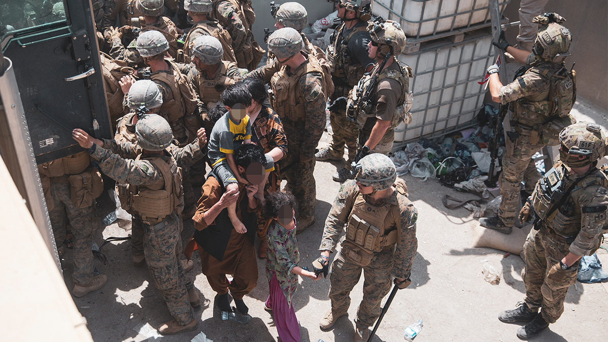 (August 20, 2021) U.S. Marines and Norweigian coalition forces assist with security at an Evacuation Control Checkpoint ensuring evacuees are processed safely during an evacuation at Hamid Karzai International Airport, Kabul, Afghanistan, Aug. 20. U.S. service members are assisting the Department of State with a non-combatant evacuation operation (NEO) in Afghanistan. (U.S. Marine Corps photo by Staff Sgt. Victor Mancilla)