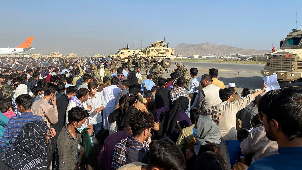 U.S soldiers stand guard along a perimeter at the international airport in Kabul, Afghanistan, Monday, Aug. 16, 2021.