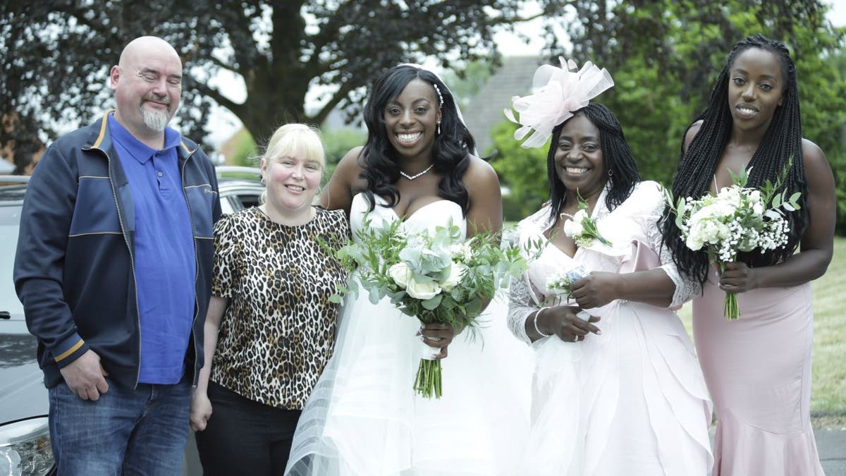 Matt and Michelle Moore (left) volunteered to drive Shenice Beirne and her family to St Barnabas Church. The trio were stranded on a backroad in Gloucester, England after Beirne's rented wedding car broke down.