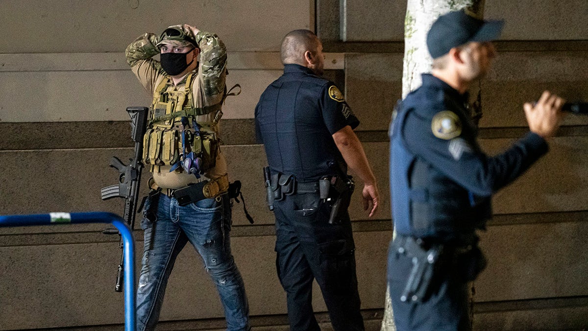 An armed far-right extremist surrenders to police after a confrontation with anti-fascists on August 8, 2021, in Portland, Oregon.