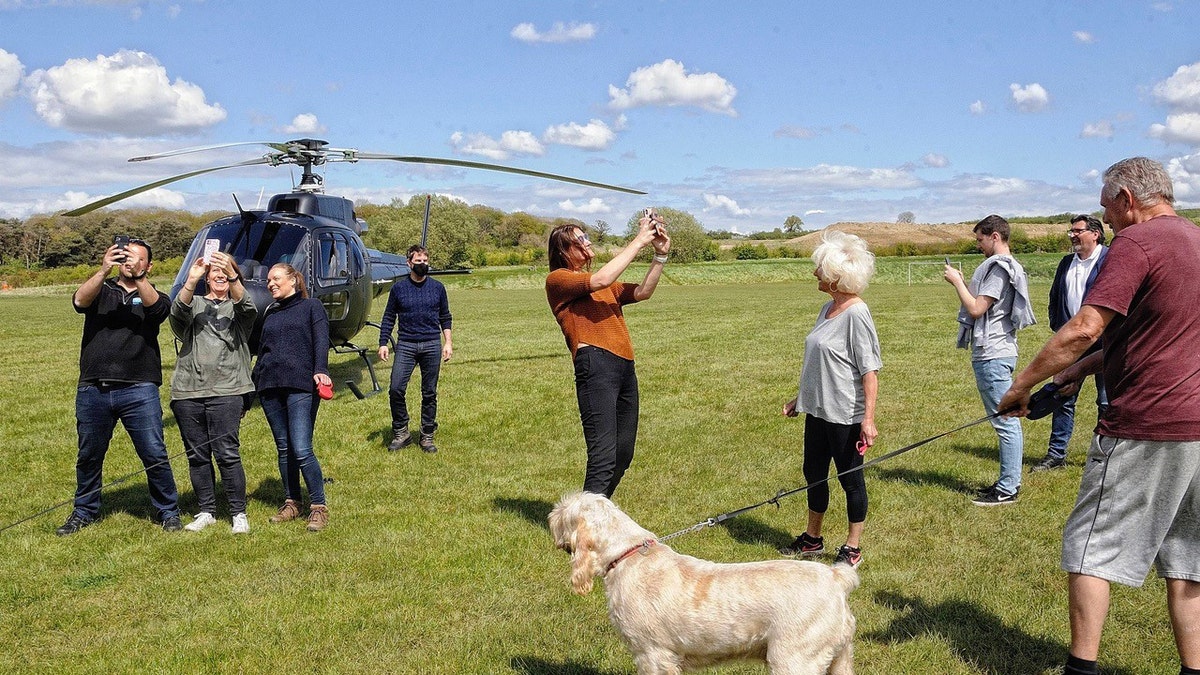 Tom Cruise (center, masked) landed his helicopter in a Warwickshire family's yard because the local airport was closed. 