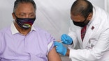 FILE - In this Friday, Jan. 8, 2021 file photo, Rev. Jesse Jackson receives the Pfizer's BioNTech COVID-19 vaccine from Dr. Kiran Chekka, Covid Administration Physician at the Roseland Community Hospital in Chicago. The Rev. Jesse Jackson and his wife, Jacqueline, have been hospitalized after testing positive for COVID-19 according to a statement Saturday, Aug. 21, 2021. He is vaccinated against the virus and publicly received his first dose in January. According to a statement released Saturday evening, the Jacksons are being treated at Northwestern Memorial Hospital in Chicago. He is 79 years old. Jacqueline Jackson is 77.  (AP Photo/Charles Rex Arbogast, File)