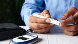 young man hand measuring diabetic on table