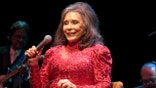 FILE - In this Aug. 28, 2016 file photo, Loretta Lynn performs in concert at the American Music Theater in Lancaster, Pa. Lynn says she is doing better after a brief hospital visit to treat an illness that kept her from attending a CMT tribute to her and other female country artists. A message posted on Lynn's official Facebook page Saturday afternoon, Oct. 20, 2018, said she is feeling better and is now resting at home. (Photo by Owen Sweeney/Invision/AP, File)