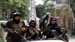 Taliban fighters display their flag on patrol in Kabul, Afghanistan, on Thursday.  (AP)