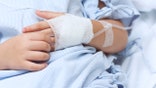 Hand of the sick child with saline solution with Space for text.