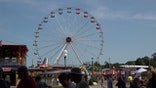 The Iowa State Fair is back as COVID-19 cases surge in the state.