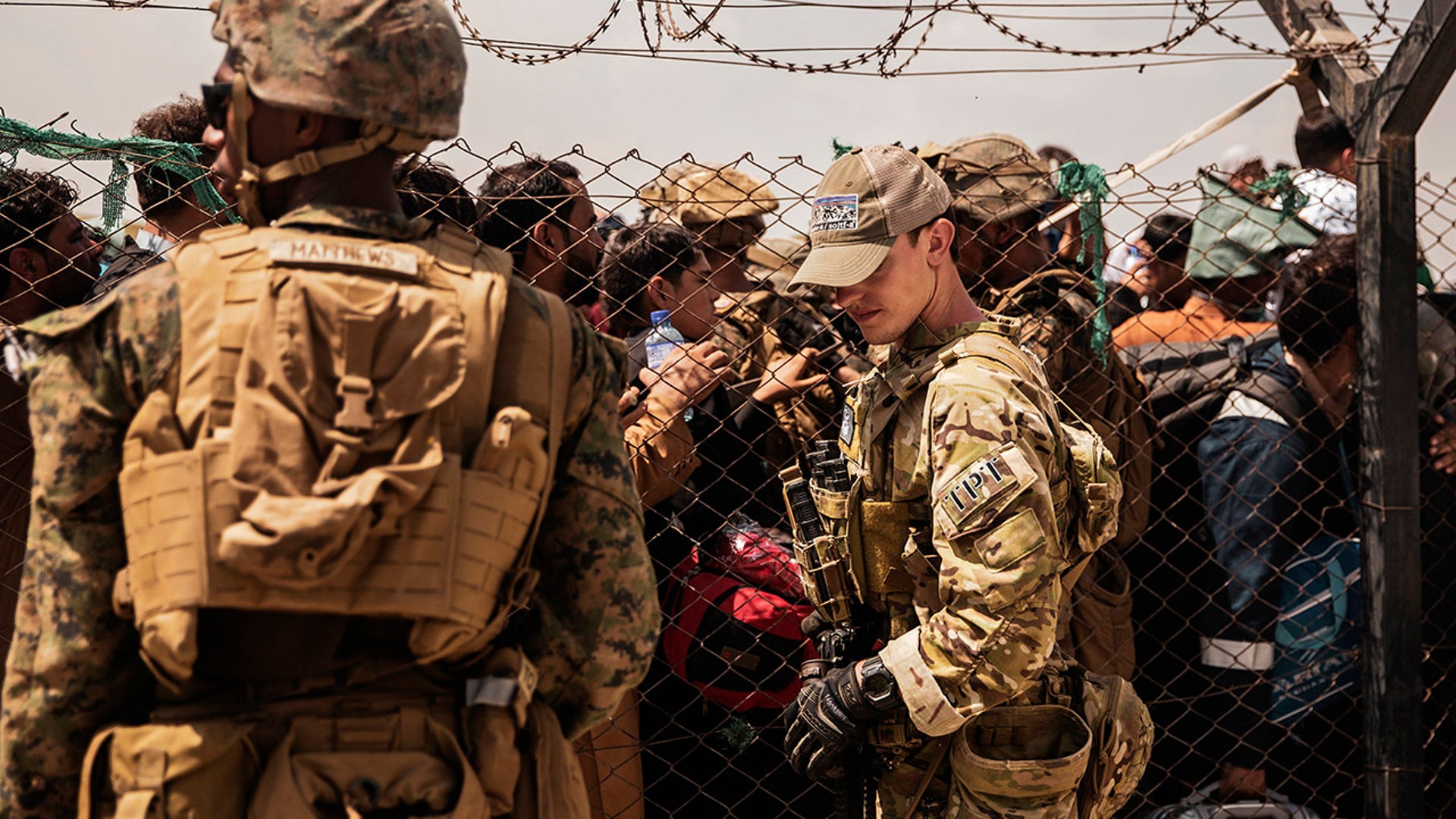 In this photo provided by the U.S. Marine Corps, U.S. service members provide assistance during an evacuation at Hamid Karzai International Airport, Kabul, Afghanistan, Sunday, Aug. 22, 2021.  (Staff Sgt. Victor Mancilla/U.S. Marine Corps via AP)