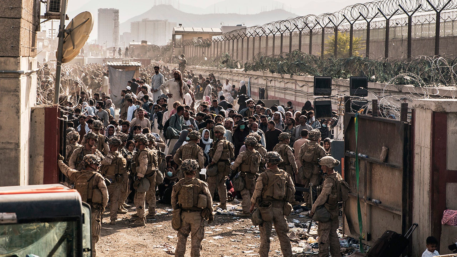 In this Aug. 21, 2021, photo provided by the U.S. Marines, U.S. Marines with Special Purpose Marine Air-Ground Task Force - Crisis Response - Central Command, provide assistance at an evacuation control checkpoint during an evacuation at Hamid Karzai International Airport in Kabul, Afghanistan. (Staff Sgt. Victor Mancilla/U.S. Marine Corps via AP)