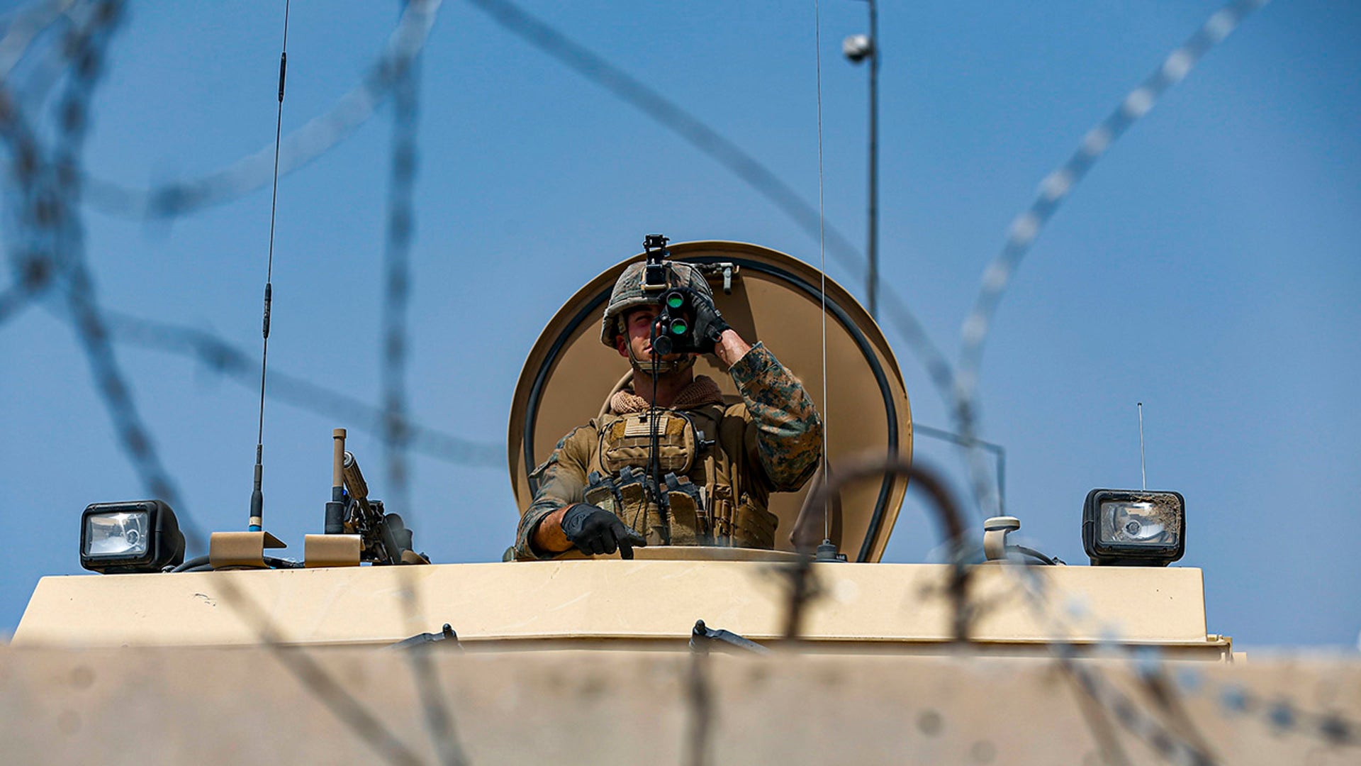 In this Aug. 21, 2021, photo provided by the U.S. Marine Corps, a U.S. Marine assigned to 24th Marine Expeditionary Unit (MEU) provides over-watch during an evacuation at Hamid Karzai International Airport in Kabul, Afghanistan. (Lance Cpl. Nicholas Guevara/U.S. Marine Corps via AP)