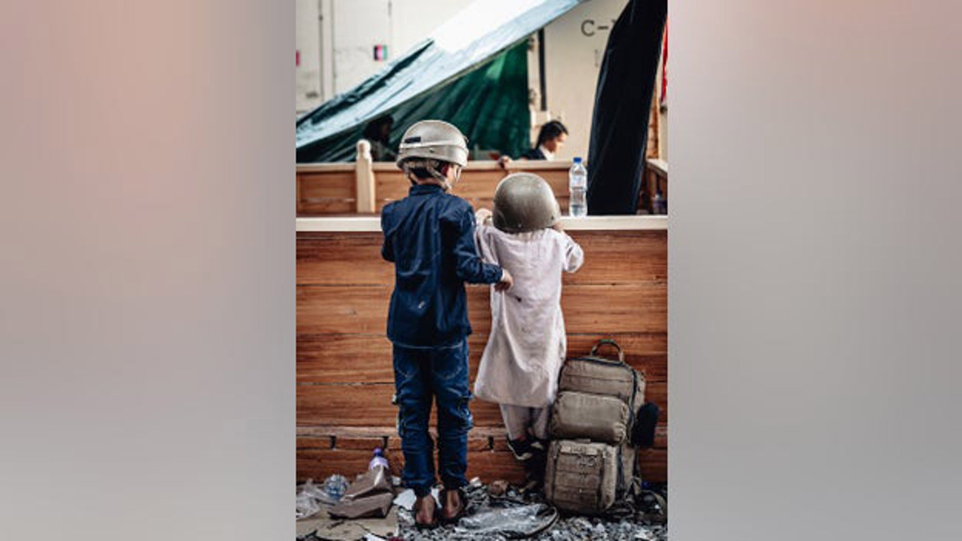 Children wait to be evacuated at Hamid Karzai International Airport on Monday.