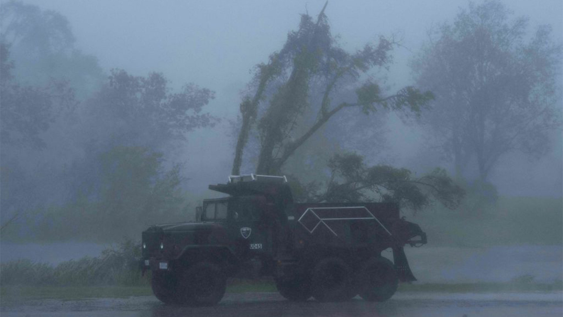 A truck is seen in heavy winds and rain from hurricane Ida in Bourg, Louisiana on August 29, 2021. - Hurricane Ida struck the coast of Louisiana Sunday as a powerful Category 4 storm, 16 years to the day after deadly Hurricane Katrina devastated the southern US city of New Orleans."Extremely dangerous Category 4 Hurricane Ida makes landfall near Port Fourchon, Louisiana," the National Hurricane Center wrote in an advisory. (Photo by Mark Felix / AFP) (Photo by MARK FELIX/AFP via Getty Images)
