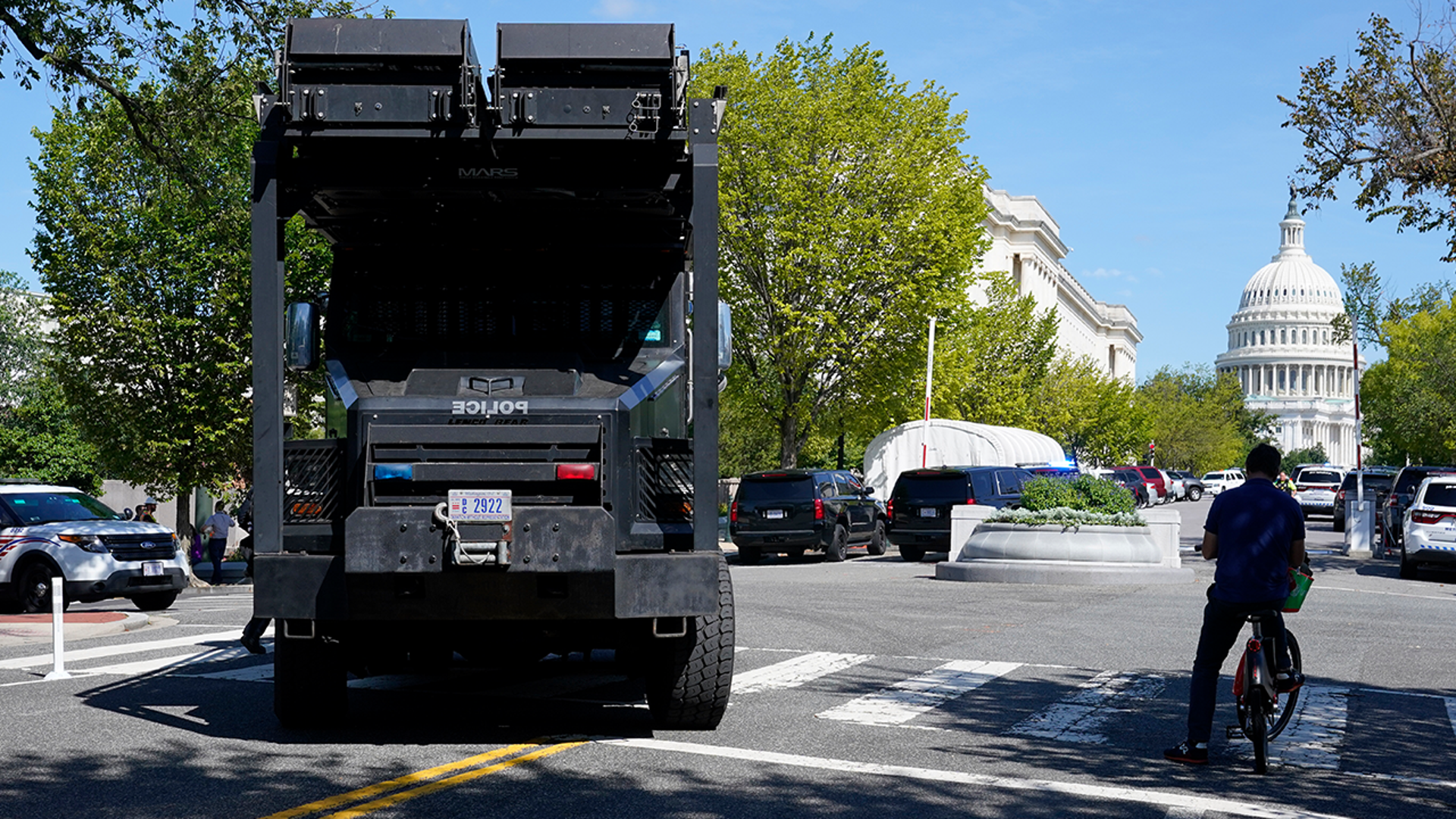 A police vehicle moves into an area near the U.S. Capitol and a Library of Congress building in Washington on Thursday, Aug. 19, 2021, as law enforcement officials investigate a report of a pickup truck containing an explosive device. (AP Photo/Patrick Semansky)