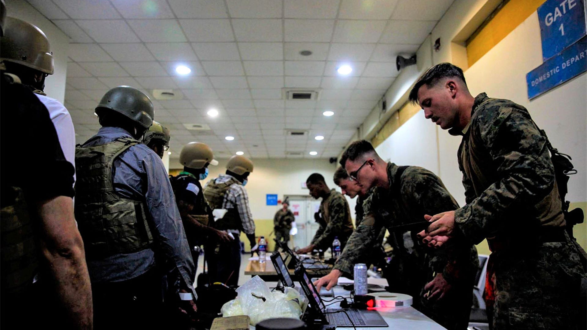 U.S. Marines from the@24thMEUMarinesprocess@StateDeptpersonnel and civilians at Hamid Karzai International Airport in Kabul, Afghanistan, before departing.