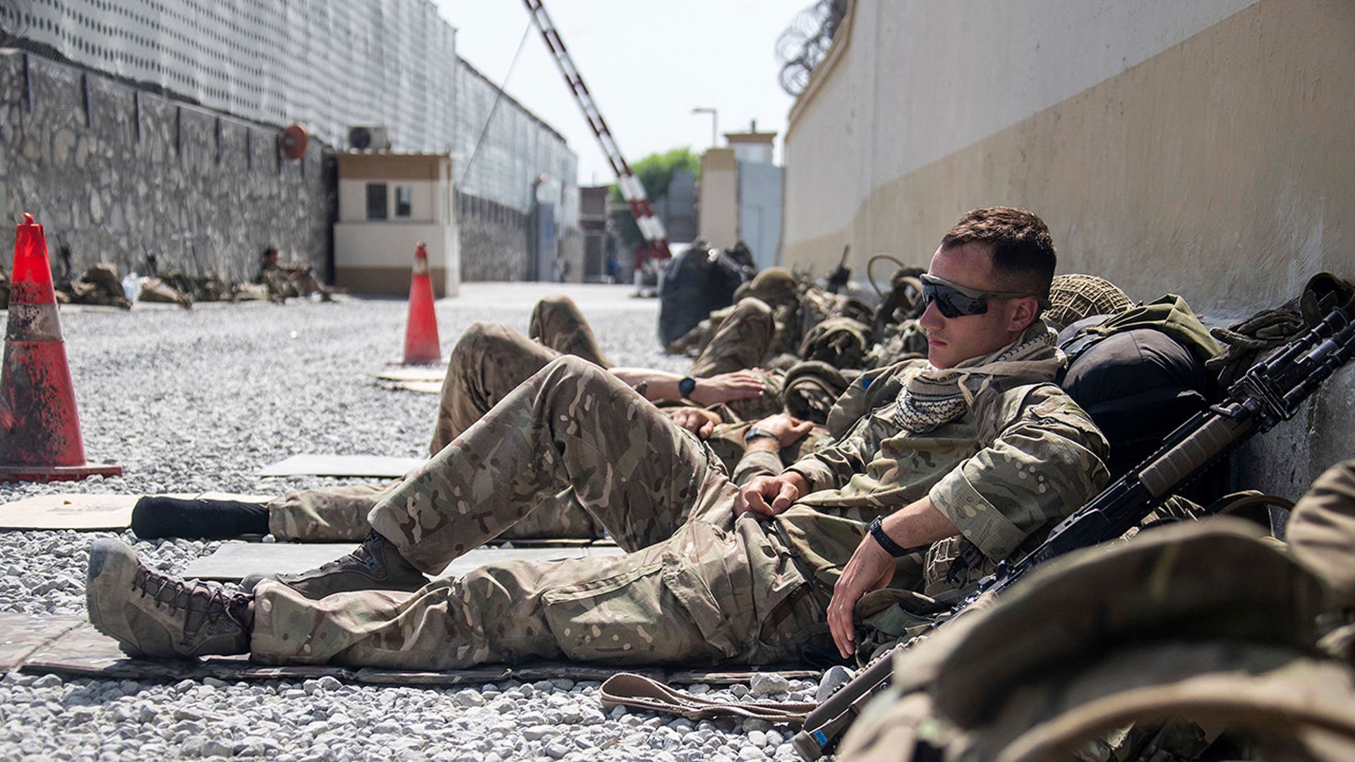 In this photo issued by Britain's Ministry of Defence (MoD), showing members of UK Armed Forces who are working to evacuate entitled personnel from Afghanistan's Kabul airport, Monday Aug. 23, 2021.  Defence Secretary Ben Wallace has said the Kabul evacuation effort is "down to hours now, not weeks" as he conceded Britain's involvement will end when the US leaves Afghanistan.  (LPhot Ben Shread/MoD via AP)