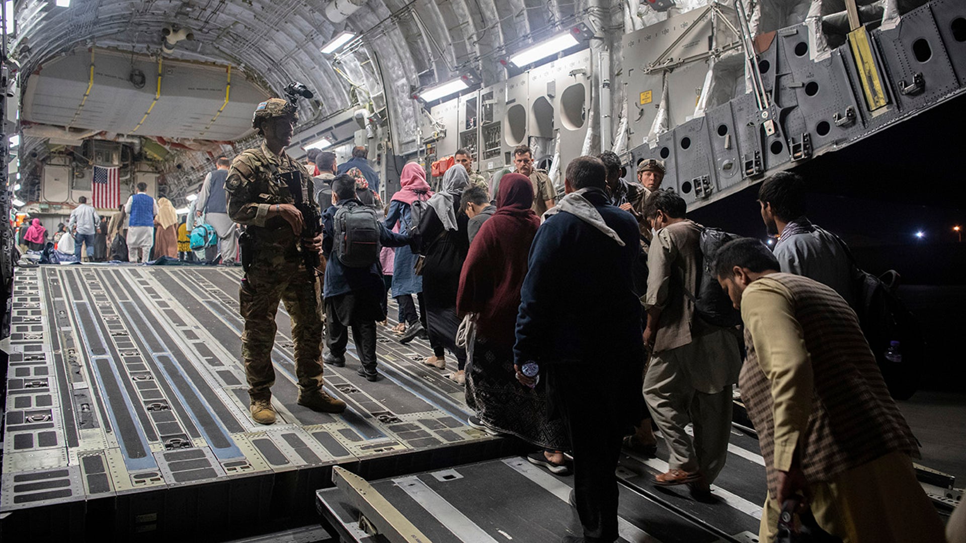 In this Aug. 22, 2021, photo provided by the U.S. Air Force, Afghan passengers board a U.S. Air Force C-17 Globemaster III during the Afghanistan evacuation at Hamid Karzai International Airport in Kabul, Afghanistan. (MSgt. Donald R. Allen/U.S. Air Force via AP)