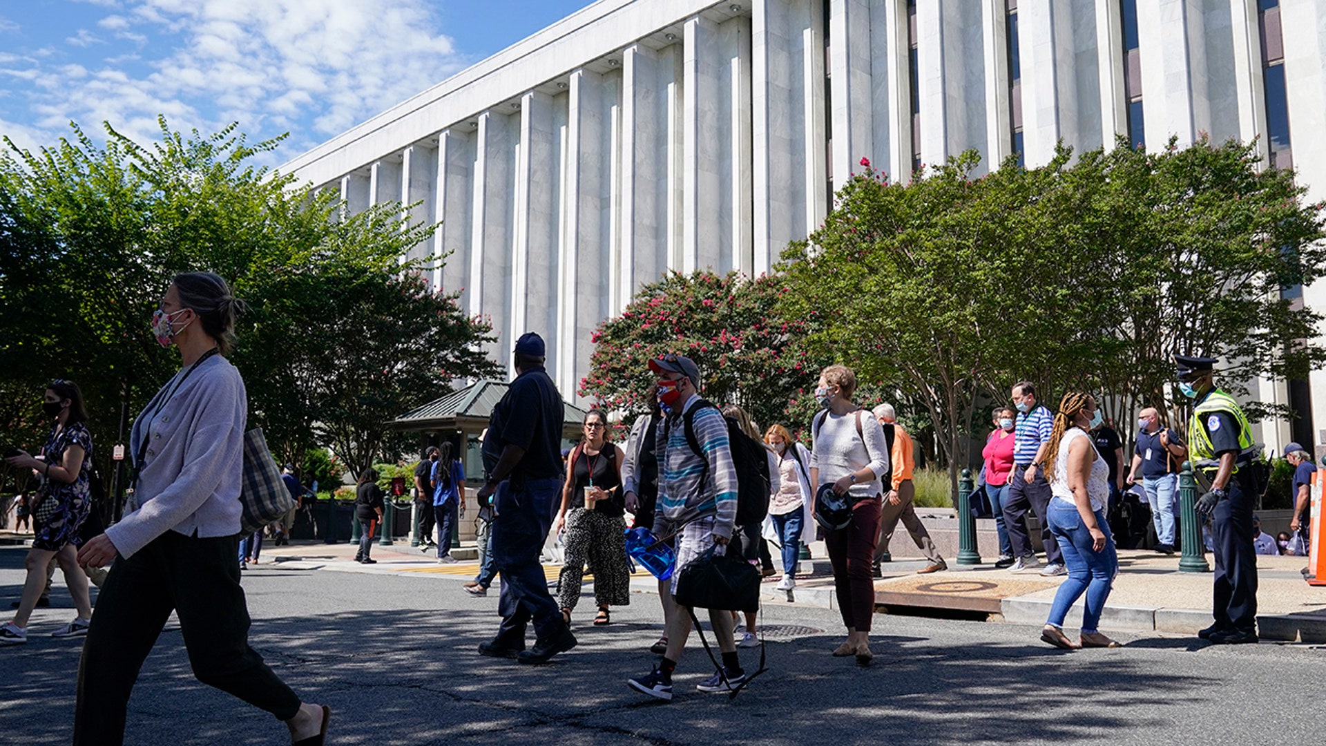 People are evacuated from the James Madison Memorial Building, a Library of Congress building, in Washington on Thursday, Aug. 19, 2021, as law enforcement investigate a report of a pickup truck containing an explosive device near the U.S. Capitol. (AP Photo/Alex Brandon)
