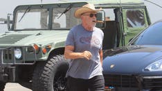 Maskless Arnold Schwarzenegger chomps on cigar as he says calling people 'schmucks' over masks crossed a line