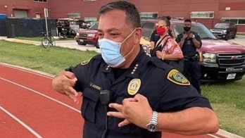 Miami police chief flashed same 'OK' hand gesture in past photo as officer he suspended, union says