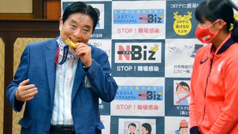 Japan mayor apologizes for biting athlete's gold medal