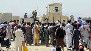 Video shows Afghans passing baby off to troops to escape Taliban