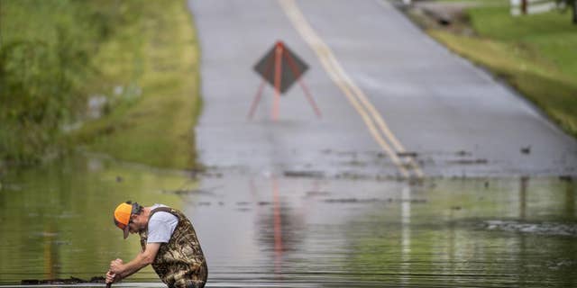 Dickson Public Works personnel check the flooding on Old Pond Lane following heavy rainfall, Saturday, Aug. 21, 2021, in Dickson, Tenn. Heavy flooding in several Middle Tennessee counties on Saturday prompted water rescues, road closures, and communications disruptions, with several people reported missing. Flash flood warnings were in effect for Dickson, Houston and Montgomery and Stewart counties on Saturday evening.