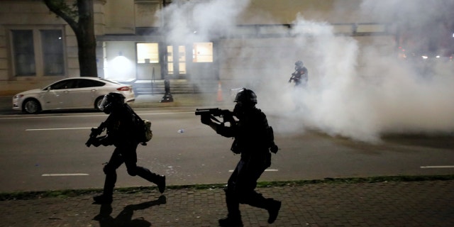 Riot police run at protesters while firing tear gas during nationwide unrest following the death in Minneapolis police custody of George Floyd, in Raleigh, North Carolina, U.S. May 31, 2020.