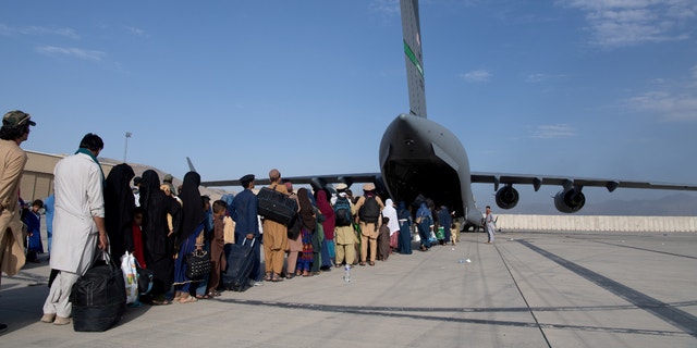 U.S. Air Force loadmasters and pilots assigned to the 816th Expeditionary Airlift Squadron, load passengers aboard a U.S. Air Force C-17 Globemaster III in support of the Afghanistan evacuation at Hamid Karzai International Airport in Kabul, Afghanistan, August 24, 2021.