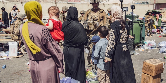 U.S. Marines with the 24th Marine Expeditionary Unit process evacuees as they pass through the Evacuation Control Center at Hamid Karzai International Airport in Kabul, Afghanistan, on August 28, 2021.