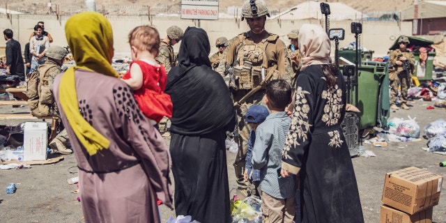 U.S. Marines with the 24th Marine Expeditionary Unit process evacuees as they pass through the Evacuation Control Center at Hamid Karzai International Airport in Kabul, Afghanistan, on August 28, 2021.