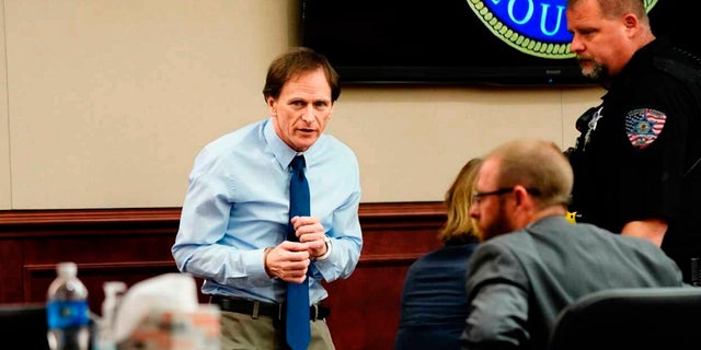 Alex Ewing enters the court for his murder trial Tuesday in an Arapahoe County Court in Centennial, Colo. Ewing was convicted Friday of killing Bruce and Debra Bennett and their 7-year-old daughter Melissa in Aurora in January 1984. (Philip B. Poston/Sentinel Colorado via AP, Pool)