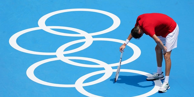 Daniil Medvedev, of the Russian Olympic Committee, pauses during a third round men's tennis match against Fabio Fognini, of Italy, at the 2020 Summer Olympics, Wednesday, July 28, 2021, in Tokyo, Japan.  (AP Photo/Patrick Semansky)