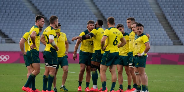 Australia players huddle up after defeating Canada in their men's rugby sevens 7-8 placing match at the 2020 Summer Olympics, Wednesday, July 28, 2021 in Tokyo, Japan. (AP Photo/Shuji Kajiyama)