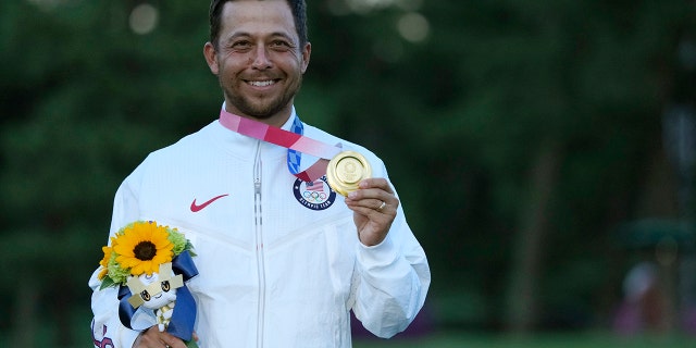 Xander Schauffele, of the United States, holds his gold medal in the men's golf at the 2020 Summer Olympics on Sunday, Aug. 1, 2021, in Kawagoe, Japan. (AP Photo/Andy Wong)
