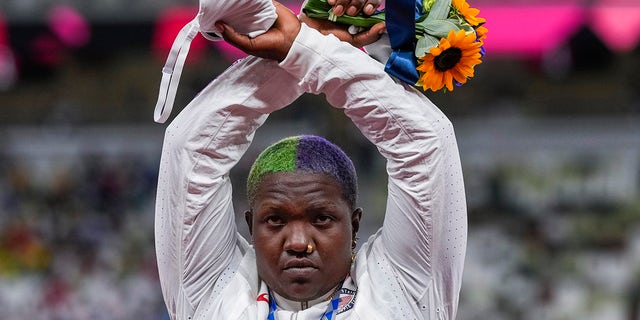 Raven Saunders, of the United States, poses with her silver medal on women's shot put at the 2020 Summer Olympics, Sunday, Aug. 1, 2021, in Tokyo, Japan.