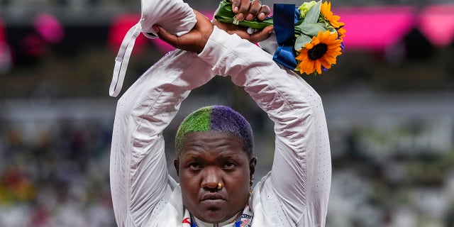 Raven Saunders, of the United States, poses with her silver medal on women's shot put at the 2020 Summer Olympics, Sunday, Aug. 1, 2021, in Tokyo, Japan.