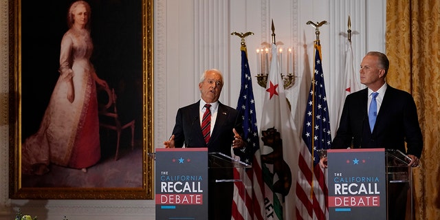 Republican candidate for California Governor John Cox, left, speaks next to fellow candidate Kevin Faulconer during a debate at the Richard Nixon Presidential Library Wednesday, Aug. 4, 2021, in Yorba Linda, Calif. California Gov. Gavin Newsom faces a Sept. 14 recall election that could remove him from office. (AP Photo/Marcio Jose Sanchez)