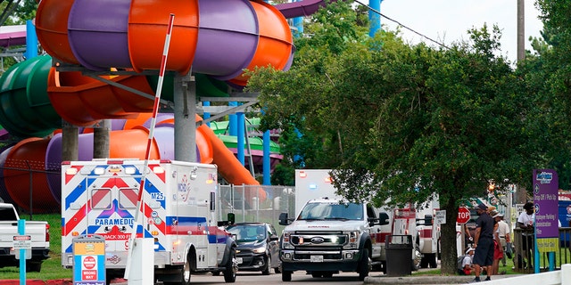 Emergency personnel vehicles are parked near the scene where people were being treated after chemical leak at Six Flags Hurricane Harbor Splashtown on July 17 in Spring, Texas.