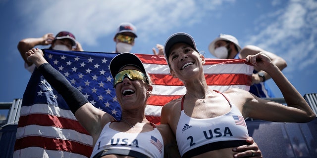 April Ross, left, of the United States, and teammate Alix Klineman celebrate winning a women's beach volleyball Gold Medal match against Australia at the 2020 Summer Olympics, Friday, Aug. 6, 2021, in Tokyo, Japan. (Associated Press)