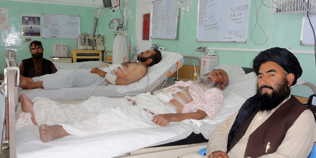 Wounded Afghans lie on a bed at a hospital after fighting between Taliban and Afghan security forces in Kandahar province south of Kabul, Afghanistan, on Thursday. 