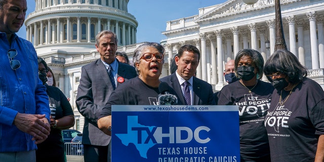 Texas state Rep. Senfronia Thompson, dean of the Texas House of Representatives, is joined by Sen. Jeff Merkley, D-Ore., left center, and other Texas Democrats, as they continue their protest of restrictive voting laws, at the Capitol in Washington, Friday, Aug. 6, 2021. (AP Photo/J. Scott Applewhite)