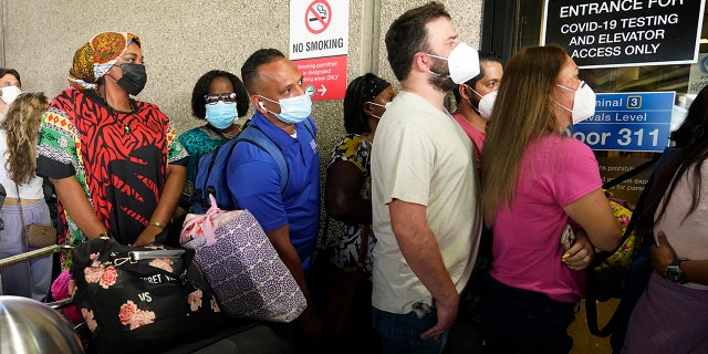 Passengers wait in a long line to get a COVID-19 test to travel overseas at Fort Lauderdale-Hollywood International Airport, Friday, Aug. 6, 2021.