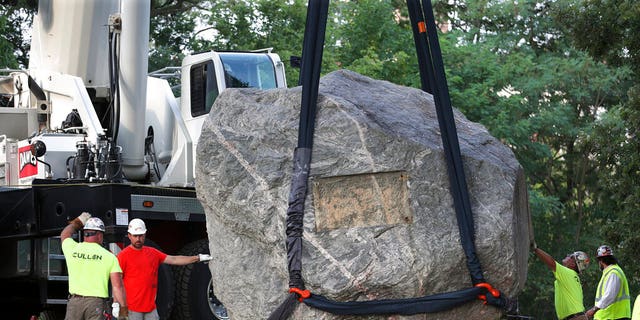 Teams are working to remove Chamberlin Rock from Observatory Hill on the UW-Madison campus in Madison, Wisconsin on Friday, August 6, 2021. The University of Wisconsin is removing the 70-ton rock from its Madison campus at the request of minority students who regard the rock as a symbol of racism.  Chamberlin Rock, at the top of Observatory Hill, is named after Thomas Crowder Chamberlin, geologist and former university president.  (Kayla Wolf / Wisconsin State Journal via AP)