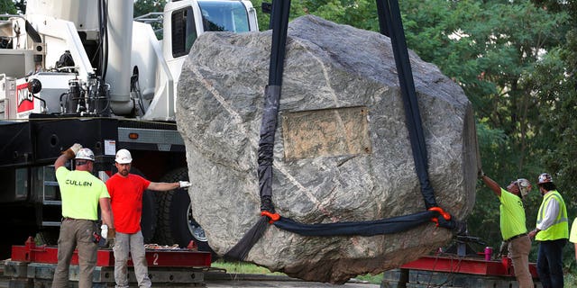 Crews work to remove Chamberlin Rock from Observatory Hill on UW-Madison campus in Madison, Wis., Friday, Aug. 6, 2021. The University of Wisconsin is removing the 70-ton boulder from its Madison campus at the request of minority students who view the rock as a symbol of racism. Chamberlin Rock, on the top of Observatory Hill, is named after Thomas Crowder Chamberlin, a geologist and former university president.     (Kayla Wolf/Wisconsin State Journal via AP)